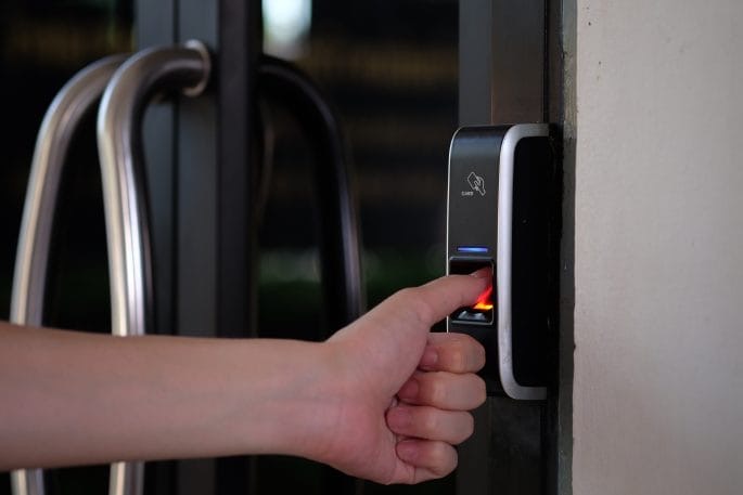 Fingerprint reader fitted beside a glass entrance